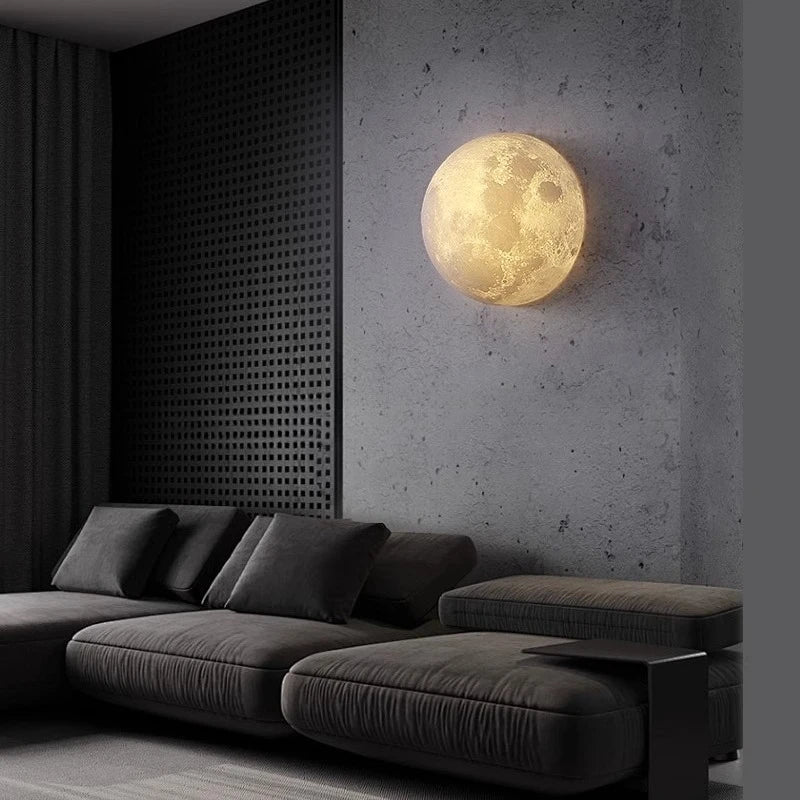 Sculptural Lunar Wall Sconce Selenya – Whole Sphere lit above a sofa, lifestyle view