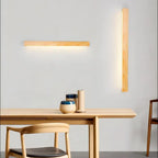 Solvela burlywood linear LED wall sconce in a dining room setting