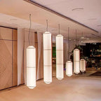 Shizumi pendant lights grouped in a modern lobby, daylight