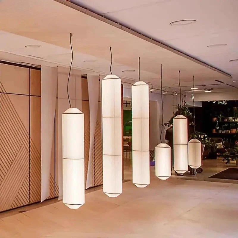 Shizumi pendant lights grouped in a modern lobby, daylight