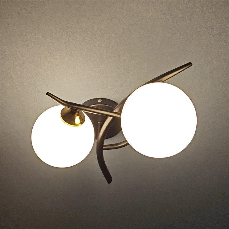Articulated Metal Arm Wall Sconce Calmeth in brushed gold – living room lifestyle