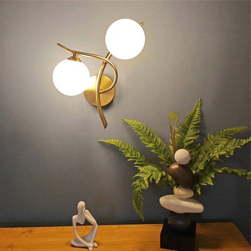 Articulated Metal Arm Wall Sconce Calmeth in brushed gold – styled lifestyle detail