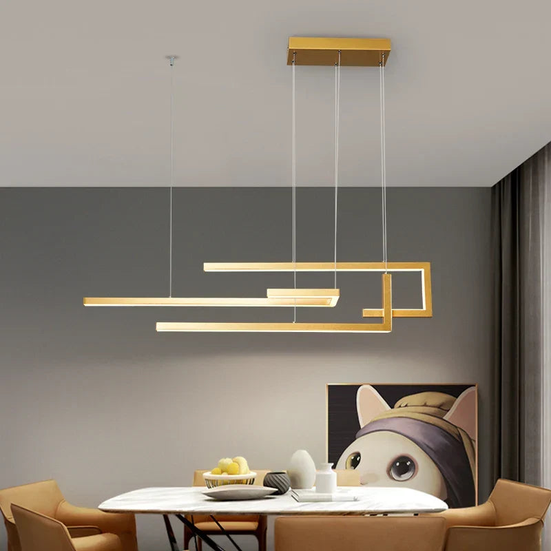Aurelux staggered linear bar pendant light in brushed gold above a dining table