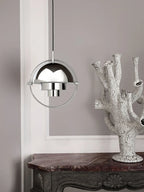 Rotating dome pendant light Axion in chrome finish, bedroom setting