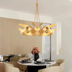 Sculptural Metal Ribbon Chandelier Karox – Brushed Gold Lifestyle over Dining Table