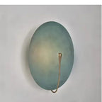 Eclipse Disc Wall Sconce – Selenyx – angled view showing pull-switch cord, Painted Blue