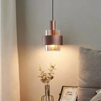 Modern Bronze Metal Cylinder Pendant Light Laevrix – Single Pendant, Bedside Lifestyle View