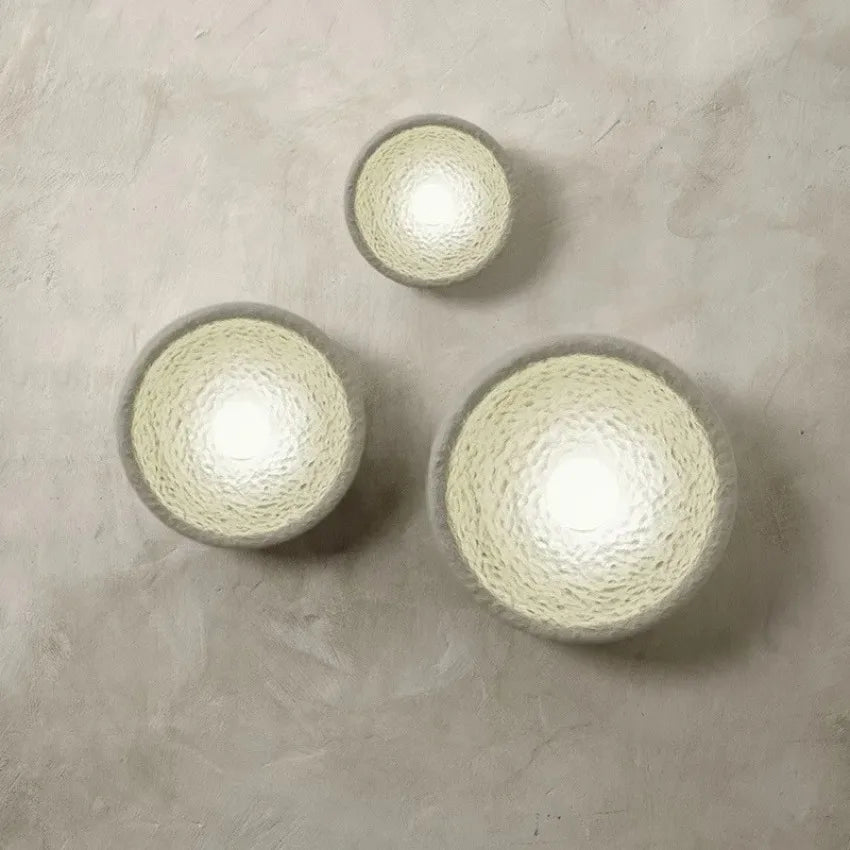 Kalvora plaster wall sconces lit, cream wall