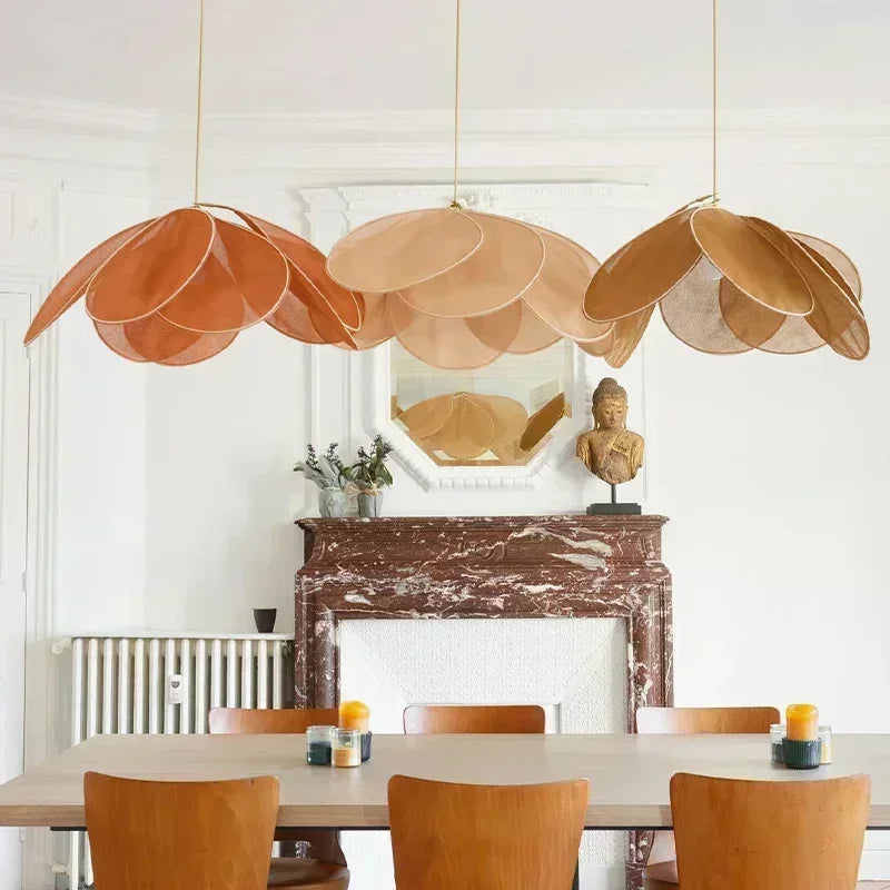 Uzaelvin fabric petal pendants – three colours clustered above dining table in Haussmann apartment