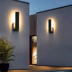 Luxenthal aluminium outdoor wall sconce illuminated on a modern facade at dusk