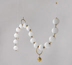 Sculptural Glass Orb Chandelier Ilnox - opal glass sphere and brass fitting detail