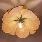 Uzaelvin petal lamp – close-up from below showing fabric texture and brass fitting