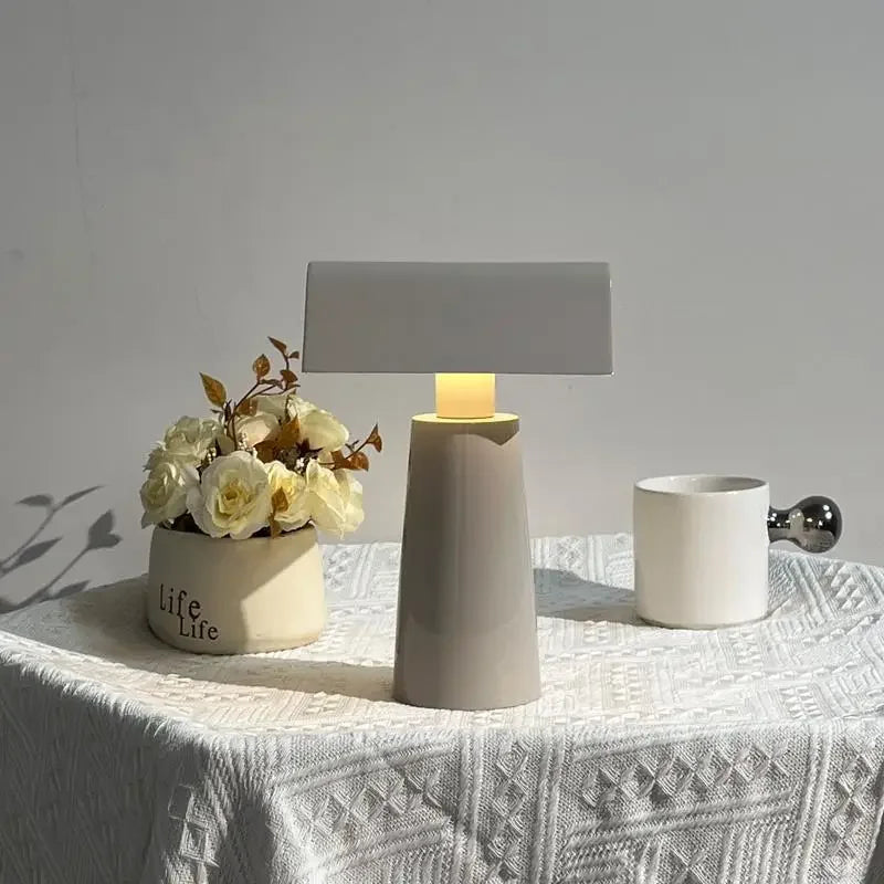 Lacquered Steel Prism Table Lamp Hovelix – Silk Grey, lit warm white on table