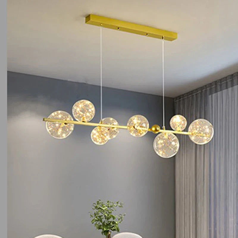Sculptural Alloy Linear Chandelier Morvelia – Gold Frame, Starlight Filament Glass, Lifestyle