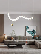 Sculptural Glass Orb Chandelier Ilnox in Brushed Gold, living room view