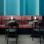 Harovant table lamp in a restaurant setting, Teal and Blush finishes