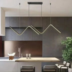 Zendrax angular zigzag LED pendant light in brushed gold above a kitchen island