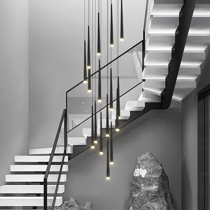 Prismex spiral cascade chandelier in Black above a staircase with sculptural stone