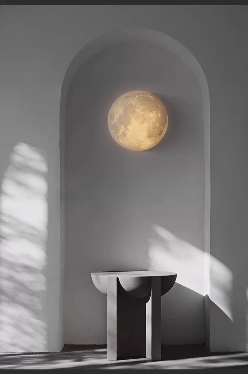 Selenya Whole Sphere lit in an archway above a stone side table