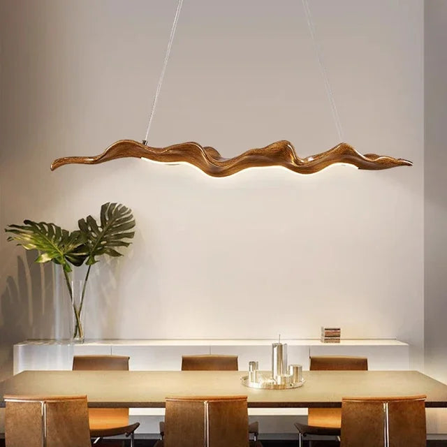 Sculptural wave-form pendant light Velorix wood-tone finish studio