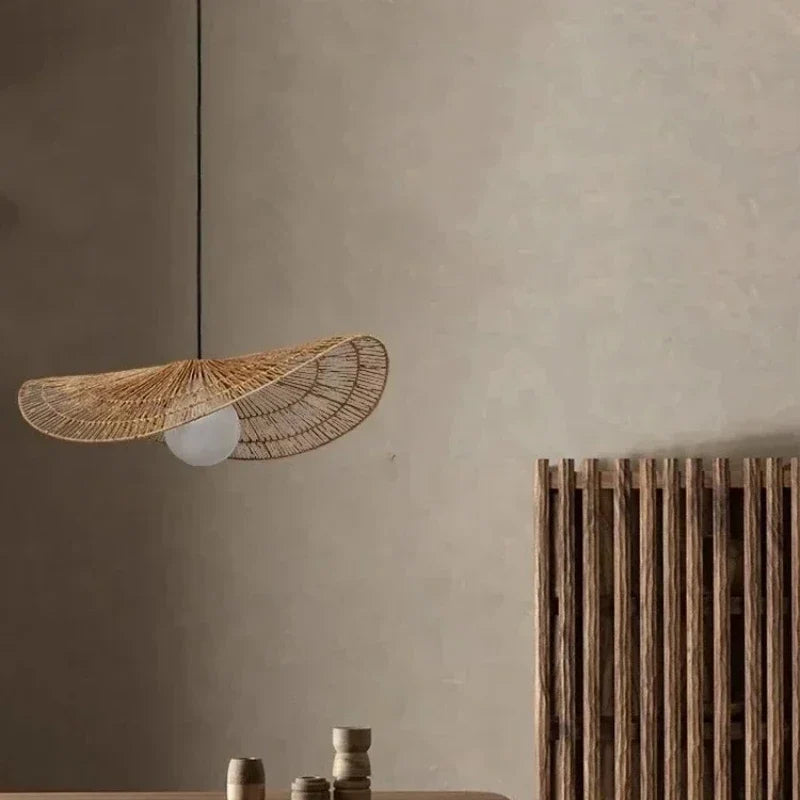 Lotara Single disc rattan pendant in a minimal interior, exposed rattan brim and E27 bulb