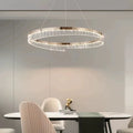 Ecelvor crystal bar ring LED chandelier over marble dining table in champagne gold