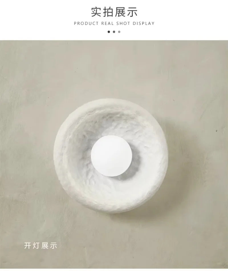 Kalvora plaster wall sconce trio above wooden bench