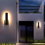 Luxenthal wall sconce lighting a modern entrance at night