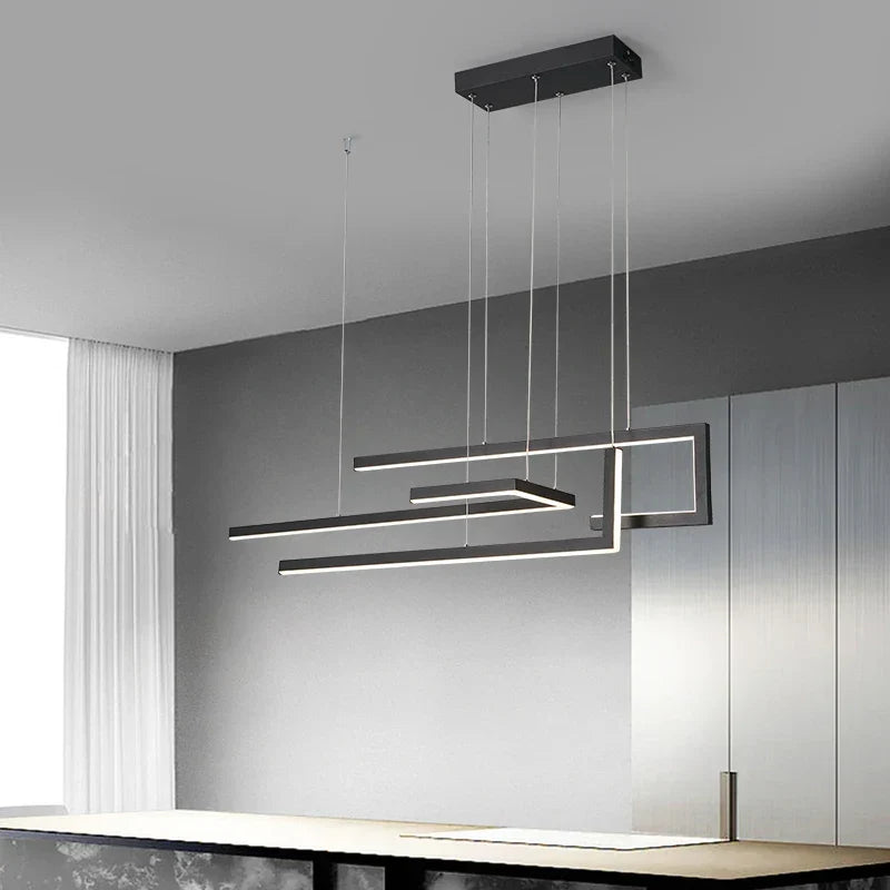 Aurelux staggered linear bar pendant light in matte black over a kitchen island