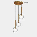 Modern Glass Globe Pendant Light Hovrix - Cascading Trio (Ø35cm), Gold & Clear Glass