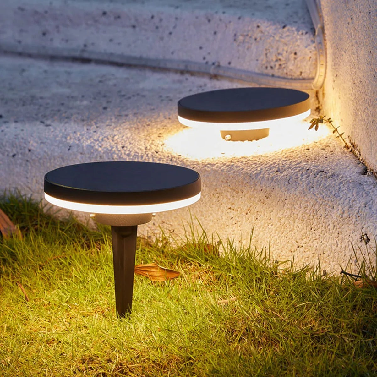 Gathrix ground light illuminating garden steps at dusk