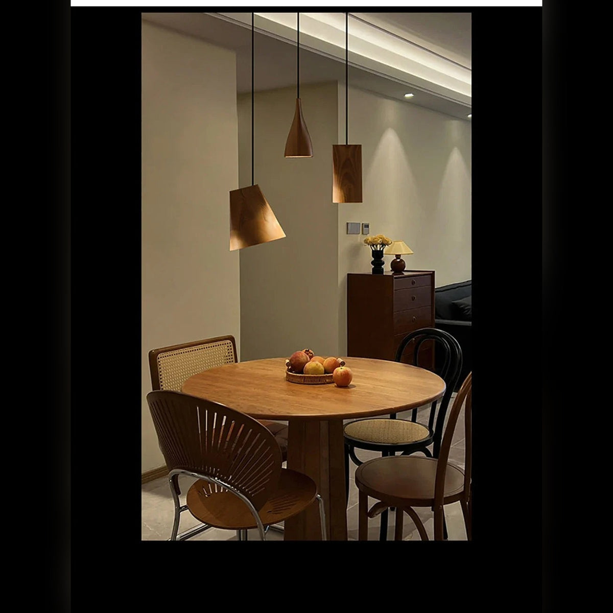 Yaelrix solid wood pendant lights over a round dining table, dark wood finish