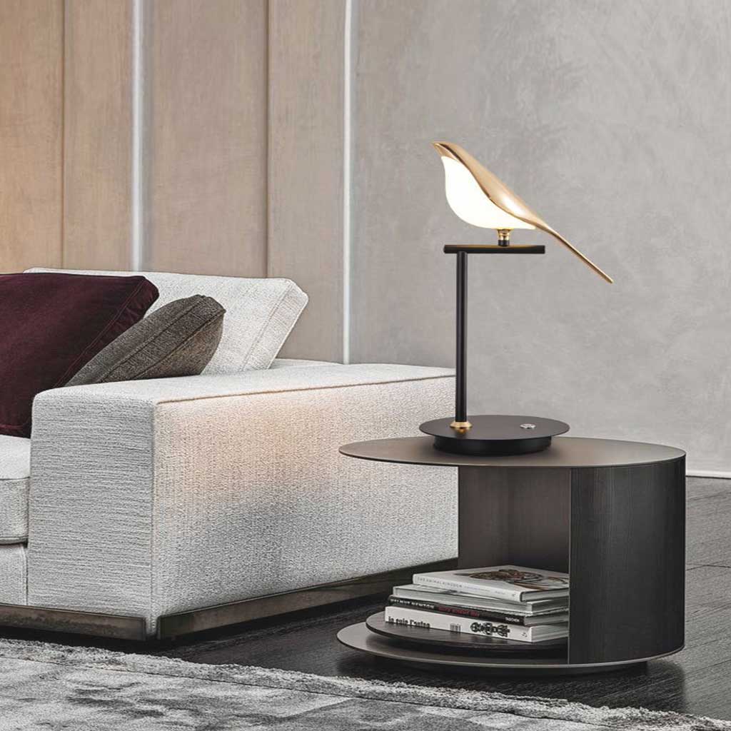 Avorix lamp – single golden bird on matte black perch glowing softly