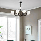 Noctivox chandelier in matte black above a window seating area