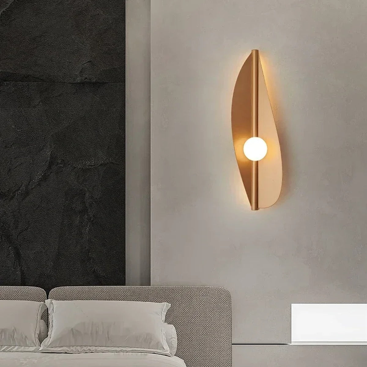Wabi-Sabi Leaf-Form Wall Sconce Velanthos — gold finish in bedroom setting