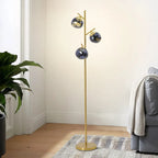 Ambris floor lamp in dark blue finish beside a sofa