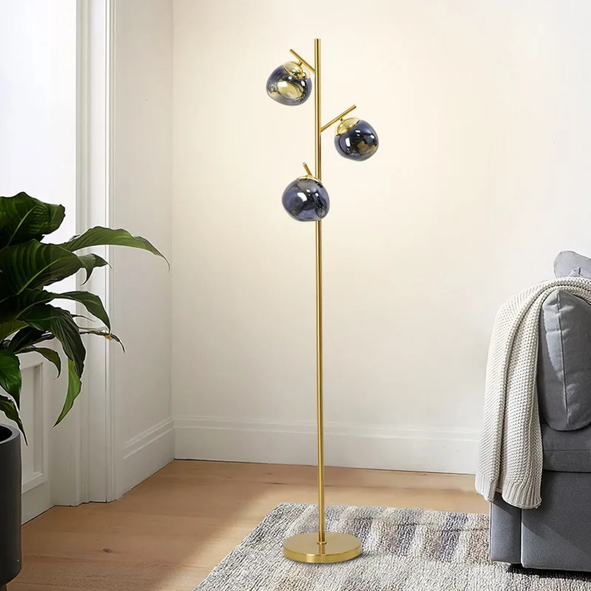 Ambris floor lamp in dark blue finish beside a sofa