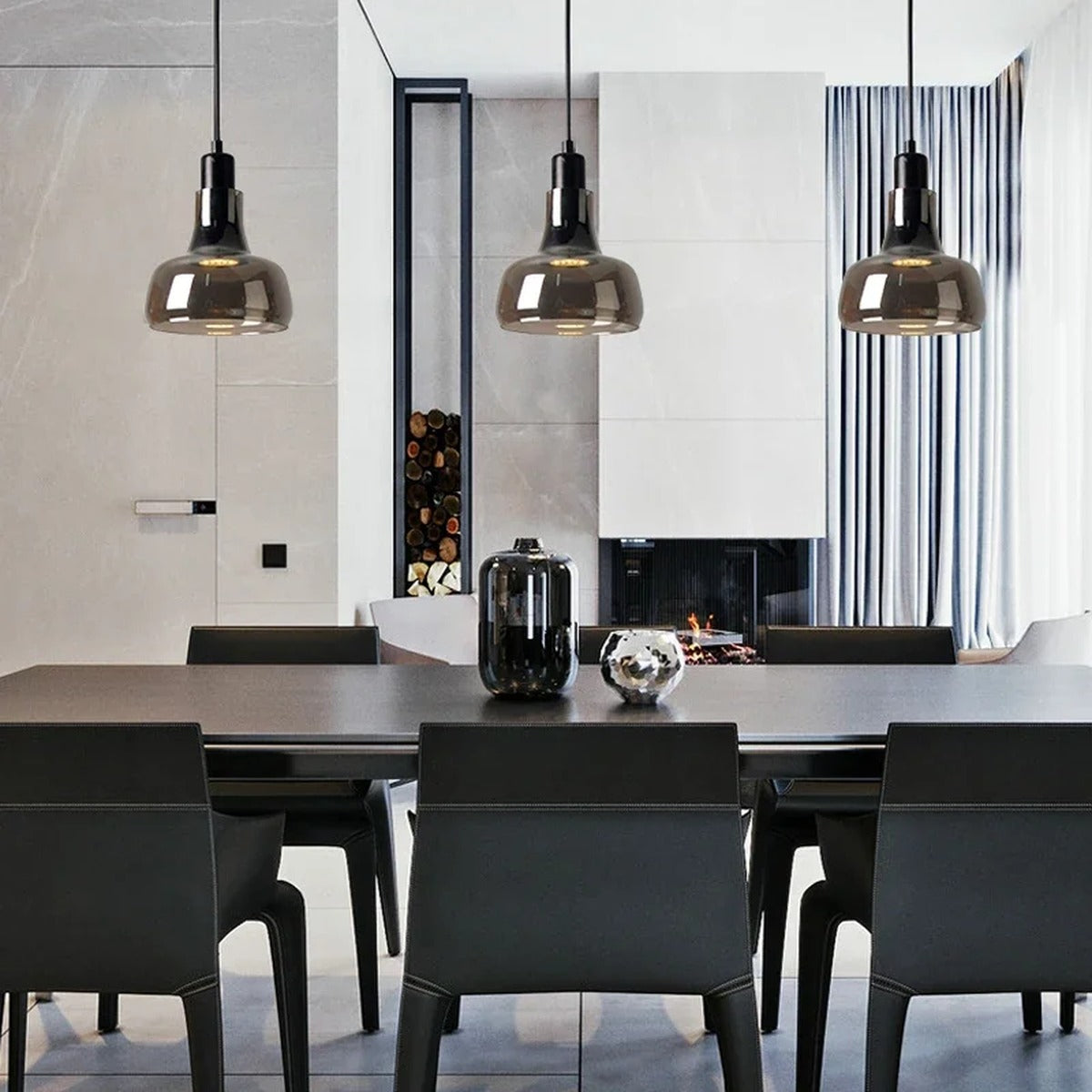 Torvalis smoked glass pendants above a dark dining table