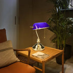 Banvex lamp – violet glass glowing on dark wood desk surface