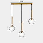 Modern Glass Globe Pendant Light Hovrix - Linear Trio (60cm Bar), Gold & Clear Glass