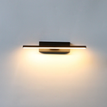 Binova wall sconce in Matte Black installed above a bathroom vanity mirror