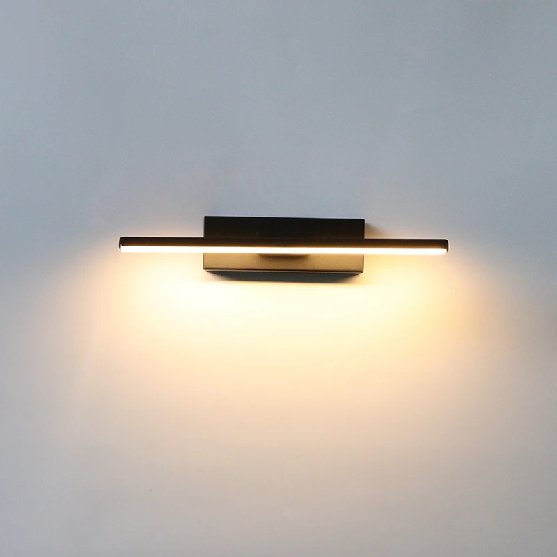 Binova wall sconce in Matte Black installed above a bathroom vanity mirror