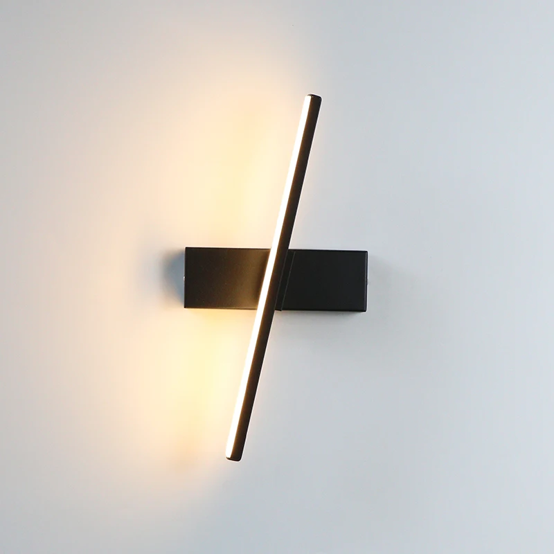 Binova wall sconce in Matte Black, rotating light bar at an angle, studio view