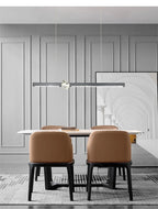 Prevoria linear LED pendant in matte black above a dining table