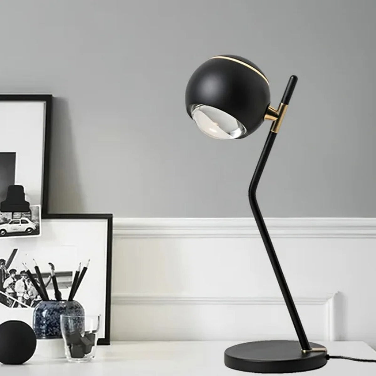 Sculptural Orb Table Lamp Ornaxis — black finish on desk