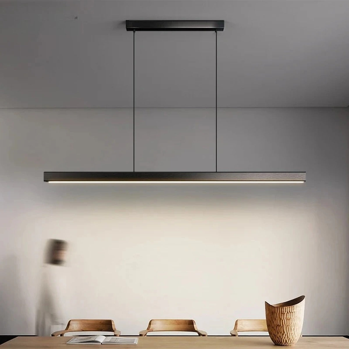 Linexa Black LED Bar Pendant Light above a dining table