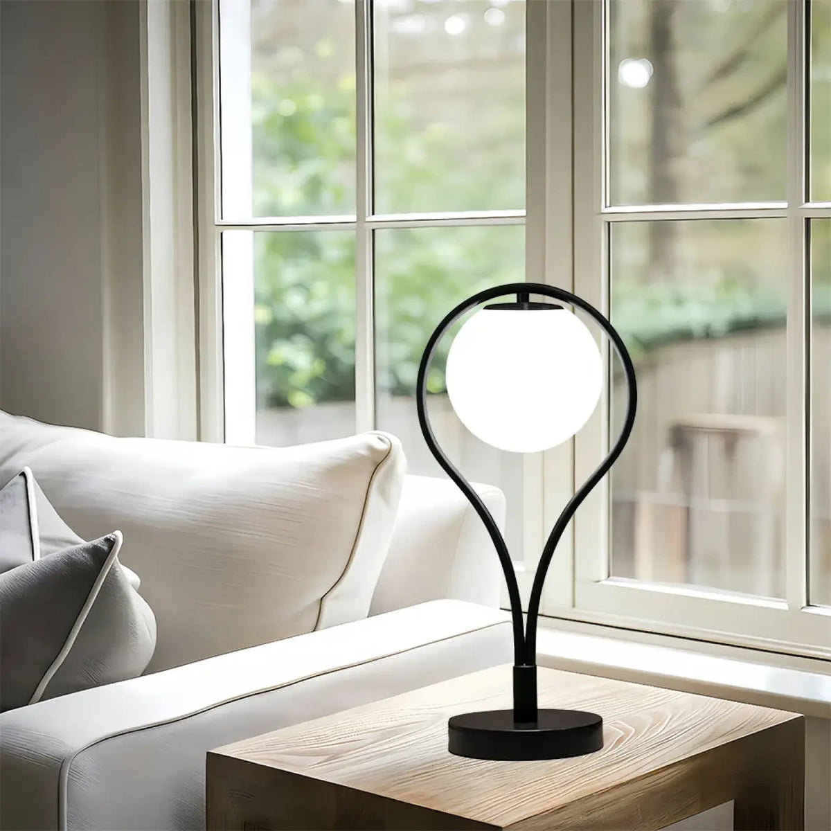 Haloria lamp – arc arm and globe detail showing warm diffused glow