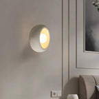Gevoria matte plaster bowl wall sconce — white version flush to textured wall showing concave bowl form