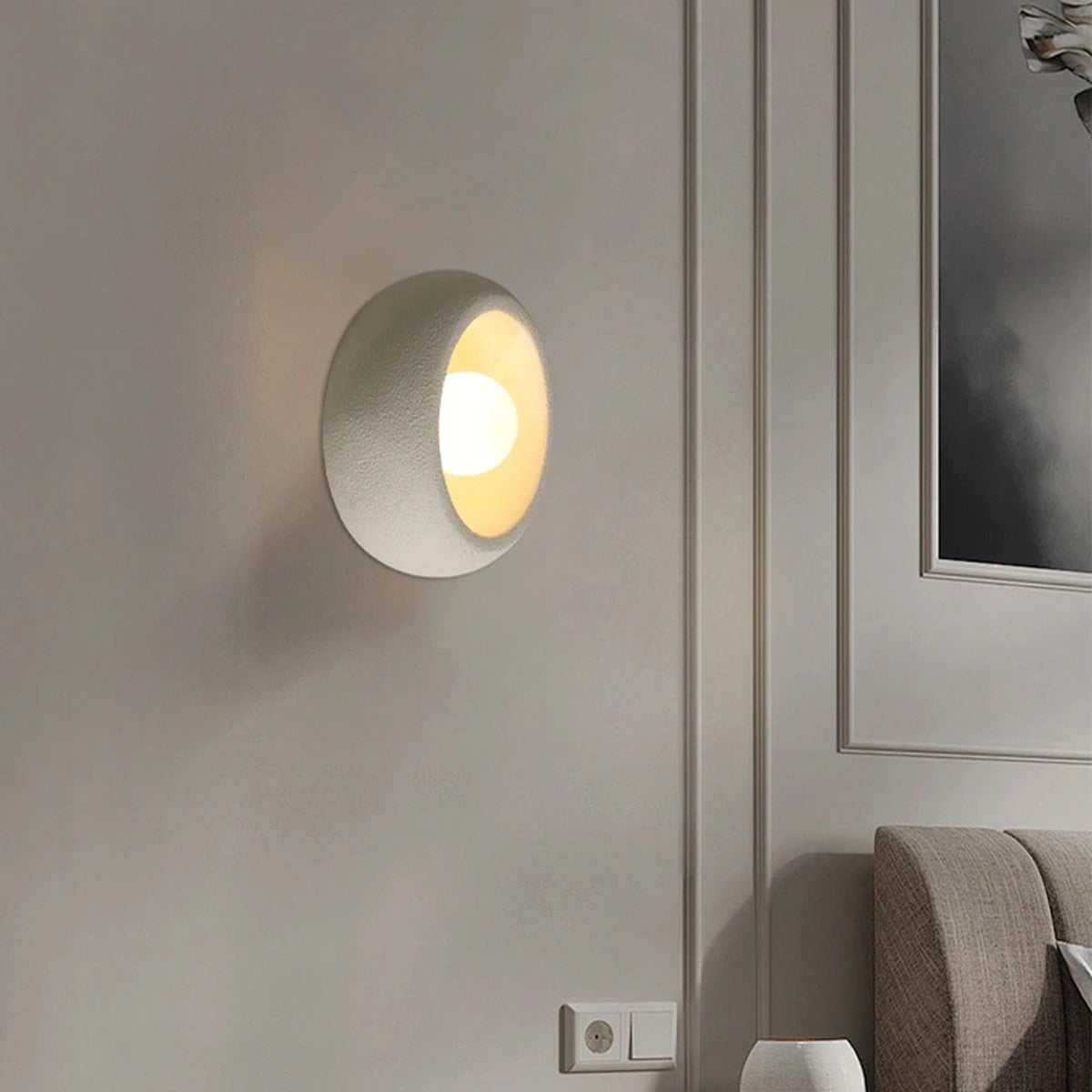 Gevoria matte plaster bowl wall sconce — white version flush to textured wall showing concave bowl form