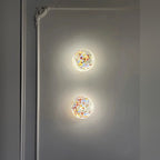 Orbinth swirl art glass wall sconce in an ornate hallway, warm ambient light